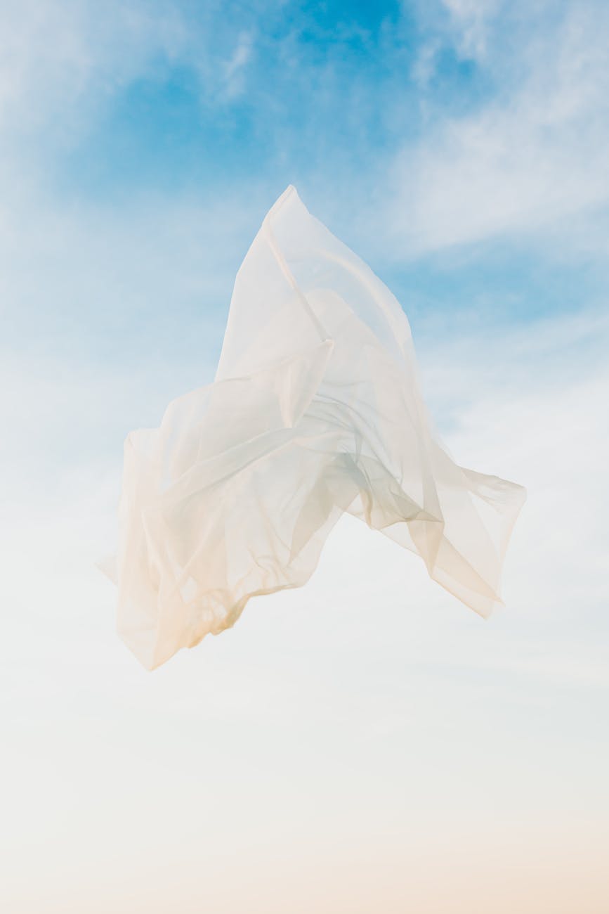 flowing white textile under blue sky